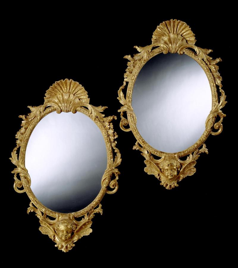 A pair of George II oval giltwood mirrors.  English, circa 1740. Height: 48 in; 122 cm Width: 31 1/4 in; 79.5 cm