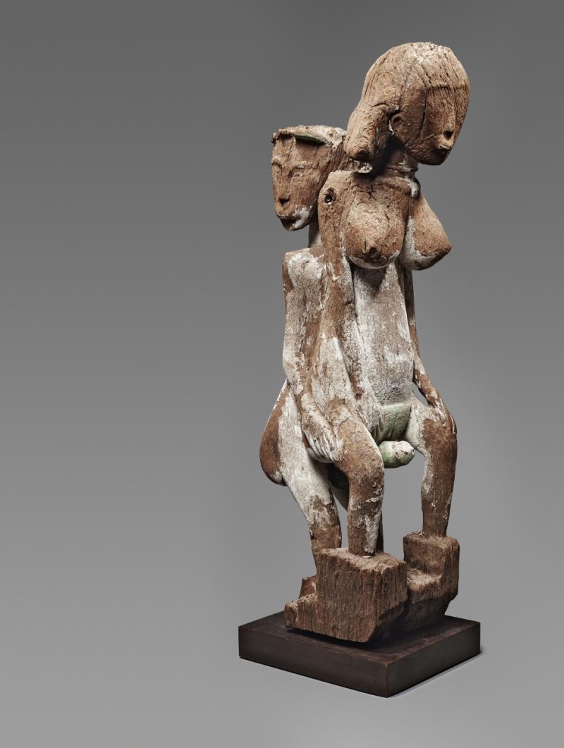 A SAKALAVA FUNERARY POST  Madagascar  Carved as an erotic couple, the male standing behind the female, weathered patina with traces of white and green pigments.  85 cm. high   Schätzpreis: €15.000 - €20.000