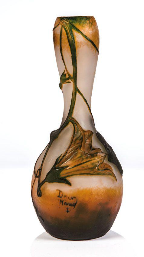 Seltene Vase mit Trichterwinde Daum Frères, Nancy, um 1910 Farbloses Glas, mit weißem Opal unterfangen, orange und grün überfangen, formgeblasen. Umlaufend reliefiert geätzter, stark plastisch modellierter Dekor. Schätzpreis:	6.000 - 7.000 EUR