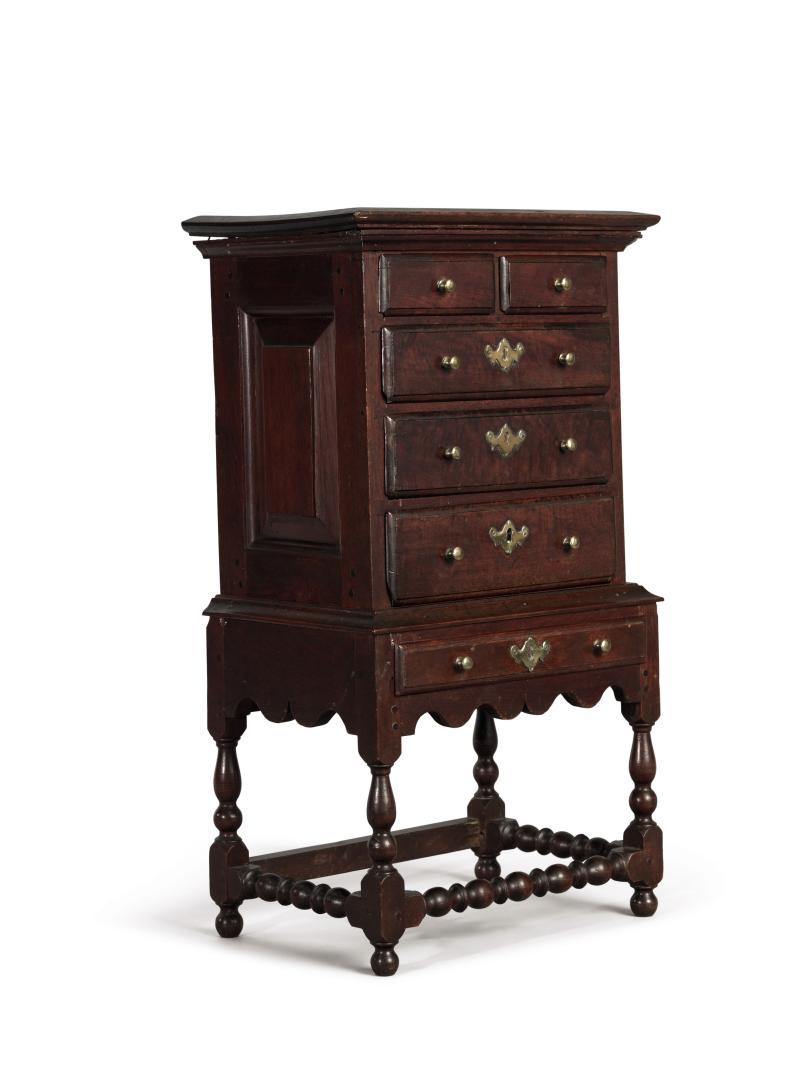 Lot 6010 Extremely Fine and Rare Miniature William and Mary Turned and Joined Walnut Flat-Top High Chest of Drawers, Chester County, Pennsylvania, circa 1725 retains a rich historic surface, appears to retain its original cast brass hardware. Height 24 3/4 in. by Width 14 1/4 in. by Depth 9 3/4 in.  Est. $80/120,000 Sold for $ 612,500