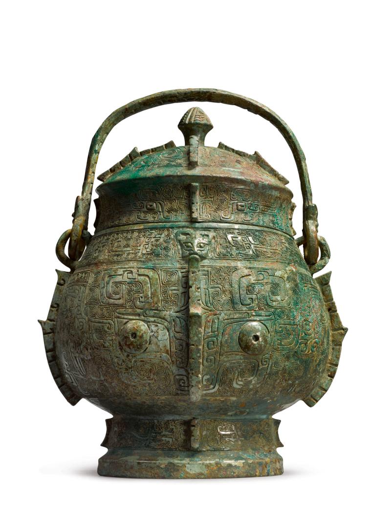 Lot 583 An Extremely Rare and Important Archaic Bronze Ritual Wine Vessel and Cover (You) Shang Dynasty, Yinxu Period Height 11 1/4 in., 28.7 cm Estimate $1.5/2.5 million Sold for $1,935,000