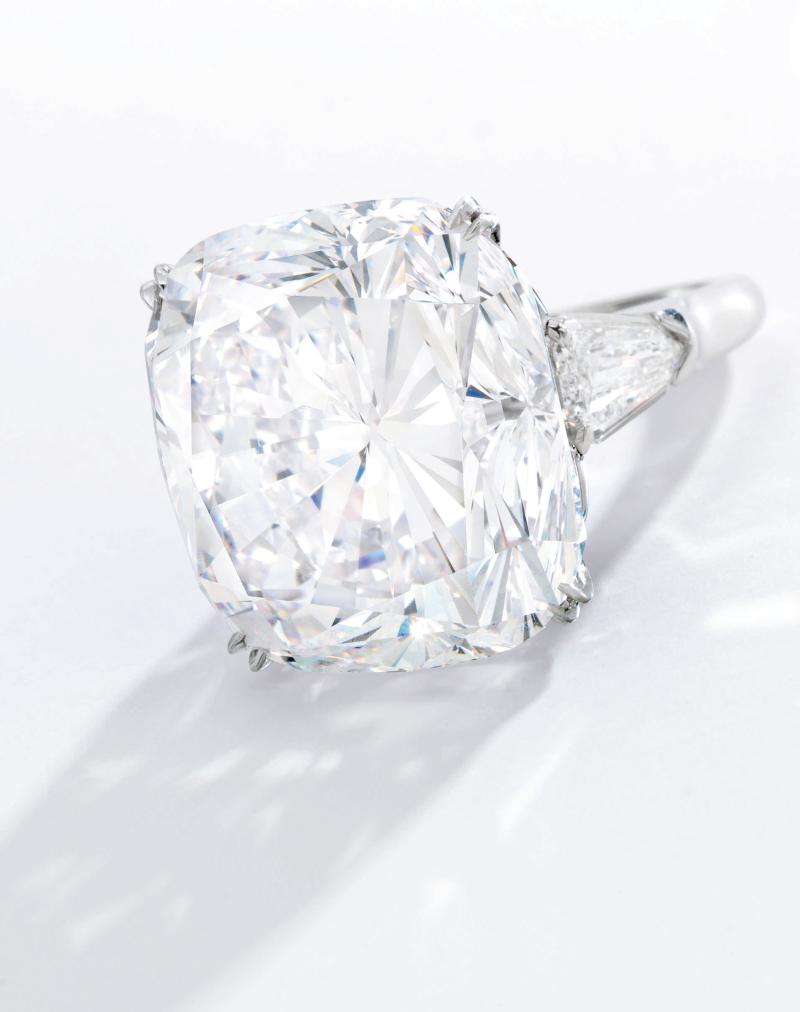 Lot 57 An Impressive Diamond Ring, Harry Winston Set with a cushion-cut diamond weighing 51.52 carats, flanked by two shield-shaped diamonds Estimate $3.5/4.5 million