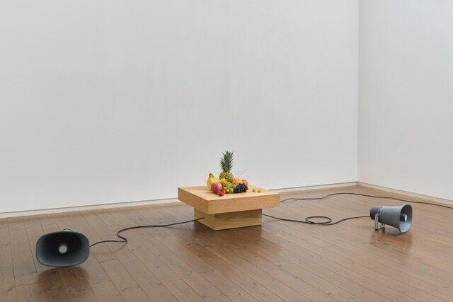 Yuko Mohri, Decomposition, 2023, seasonal fruits, wooden pedestal, computer, audio, speaker. Courtesy the artist and Yutaka Kikutake Gallery