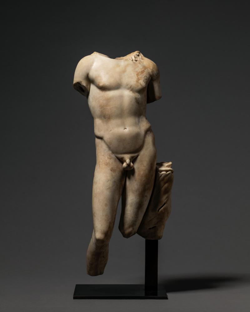 COLNAGHI  Torso of a male divinity Roman, late Republic or early Imperial, circa 1st century B.C. – 1st century A.D. Marble H 54.6 x w 21.6 x D 12.7 cm